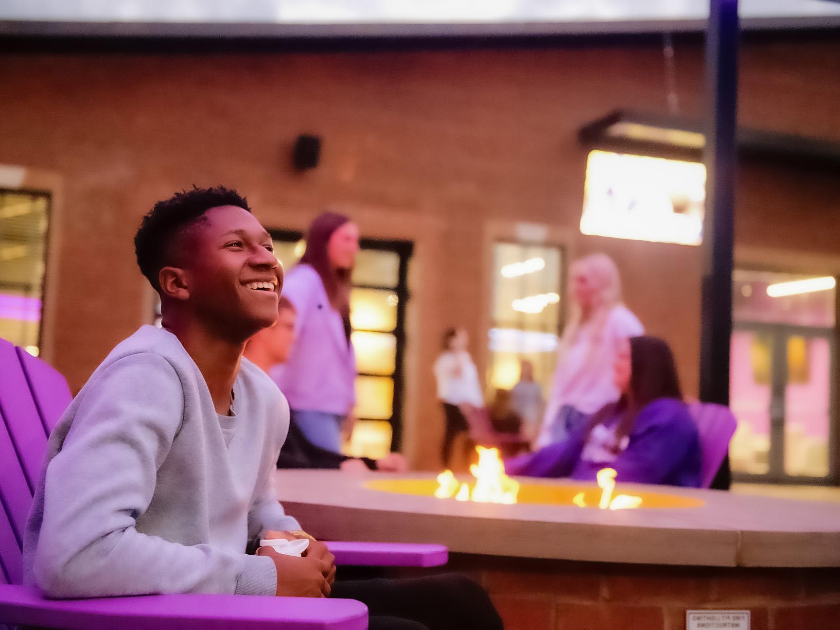 Students enjoying the fire pits on the Campus Grounds patio